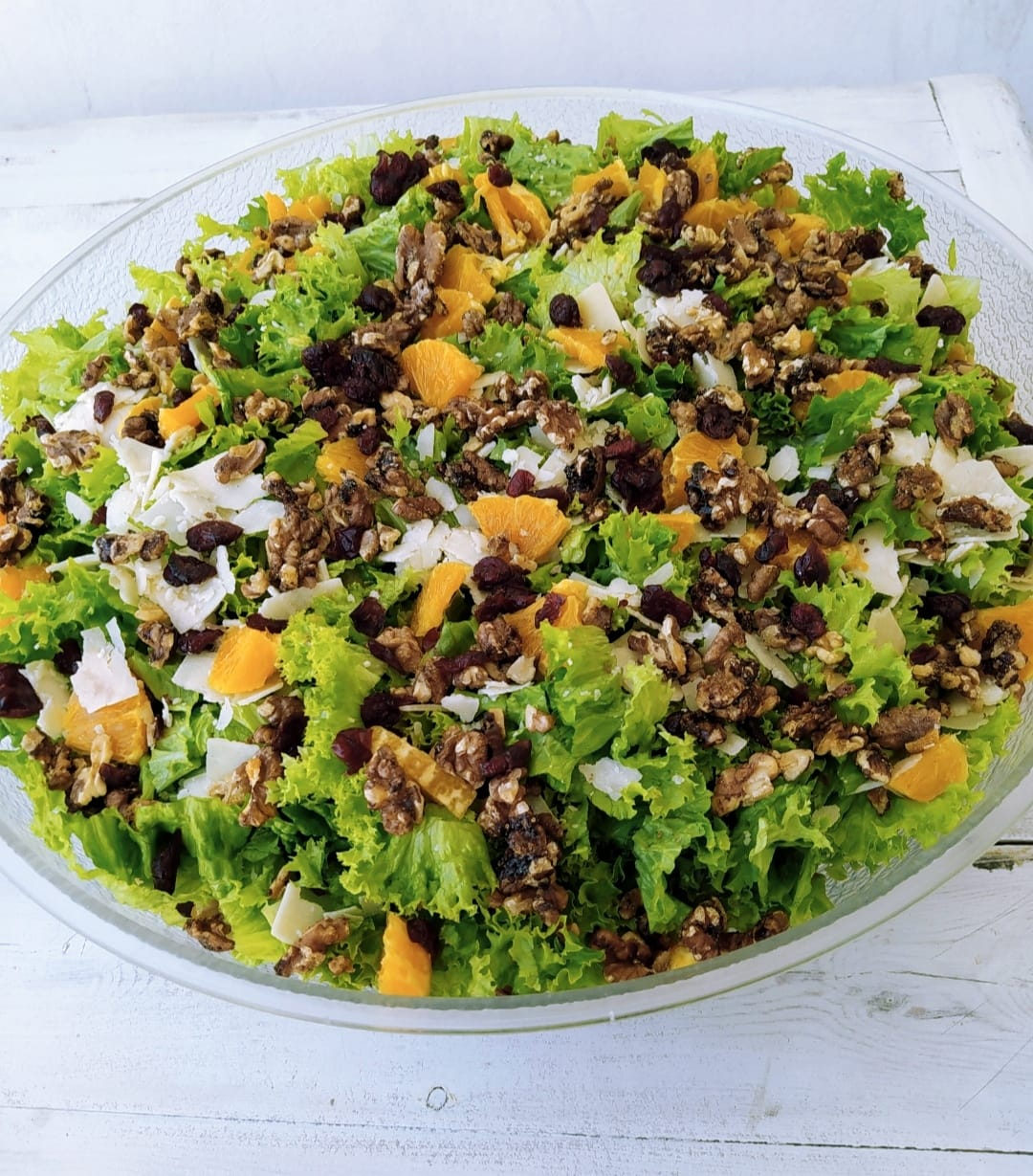 Fresh green salad with nuts and fruit