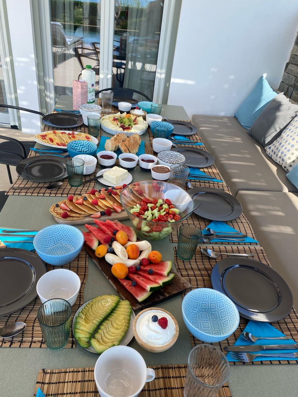 Outdoor villa table set with Greek dishes in Paros